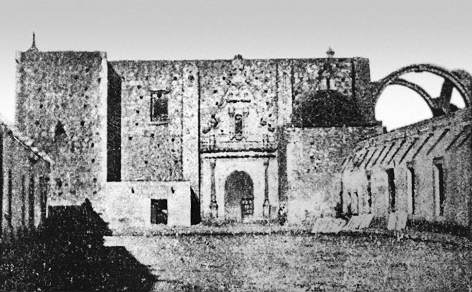 Fotografía de la fachada lateral de la iglesia y patio del colegio, vistos desde el suroeste